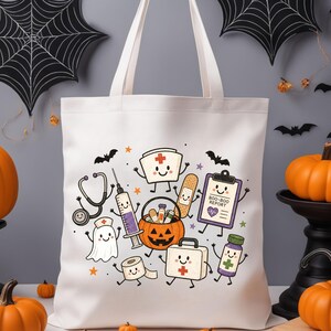 May include: A white tote bag featuring a colorful graphic print of cartoon medical items including a stethoscope, syringe, nurse cap, bandage, clipboard labeled BOO-BOO REPORT, jack-o'-lantern bucket, toilet paper roll, and first aid kit.