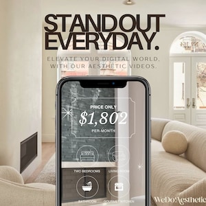 May include: A smartphone screen displaying a digital marketing service for aesthetic videos. The screen shows a price of $1,802 per month for a package that includes two bedrooms, a living room, a bathroom, and a gourmet kitchen. The phone is in front of a white couch and a fireplace.