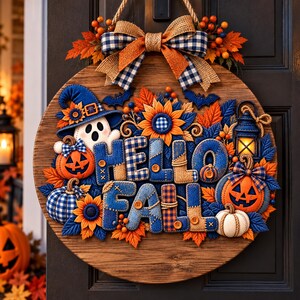May include: A round wooden door sign featuring the text HELLO FALL in blue and tan fabric letters. The sign is decorated with a ghost in a blue hat, orange jack-o'-lanterns, sunflowers, blue leaves, a lantern, and a blue and tan plaid bow.