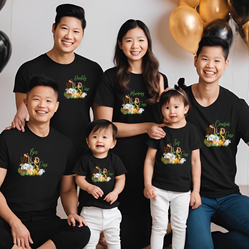 May include: A family of five wearing black t-shirts with a jungle animal theme. The shirts have the words "Bro", "Sis", "Mommy", "Daddy", and "Cousin" with the number "One" on each shirt.