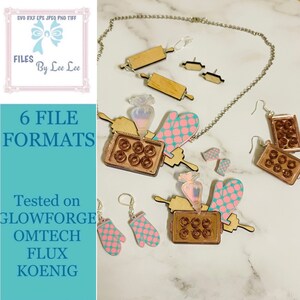 May include: A set of laser cut jewellery featuring a baking theme. The necklace features a rolling pin, a baking pan, a piping bag, and a pink oven mitt. The earrings are a pair of oven mitts and a pair of baking pans. The jewellery is made of wood and acrylic.