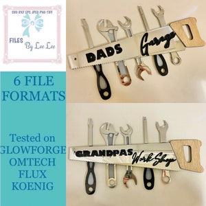 May include: A silver saw blade with a wooden handle. The saw blade has black text that reads "DADS Garage" and "GRANDPAS Work Shop". There are several wrenches and screwdrivers attached to the saw blade.