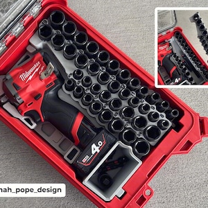 May include: A red Milwaukee tool case with a clear lid, containing a red and black power drill, a battery, and a variety of black sockets. The case is open, revealing the tools neatly organized inside. The text "Milwaukee FUEL" is visible on the drill.