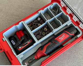 May include: A red tool case with a gray insert containing a Milwaukee brand rotary tool, a battery, and various sanding attachments. The case has a clear lid.