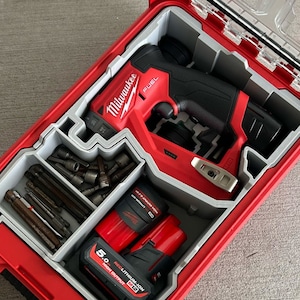May include: A red Milwaukee FUEL 2804-20 M18 FUEL 1/4" Hex Impact Driver with a red and black battery and a gray and red tool case with a variety of bits and attachments.