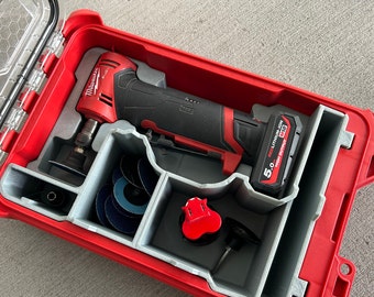 May include: A red and black cordless angle grinder with a battery and accessories in a red carrying case. The grinder has a 5.0 Ah REDLITHIUM-ION battery with HIGH OUTPUT written on it.