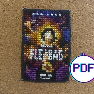 May include: A cross-stitch pattern featuring a colorful image of a person with the word "PLEASE" written below. The pattern is framed in a black border and is mounted on a corkboard.