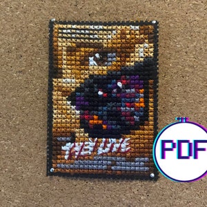 May include: Cross stitch pattern featuring a colorful, abstract design with the text "Hey Dude" in a black frame. PDF download.
