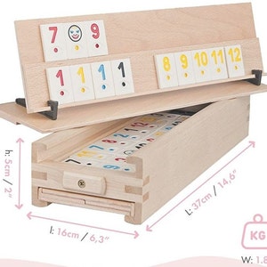 May include: A wooden box with a sliding drawer containing a set of dominoes. The box is 14.6 inches long, 6.3 inches wide, and 2 inches high. The dominoes are numbered 1 through 12 and have a smiley face on the blank side. The box weighs 1.8 kg.