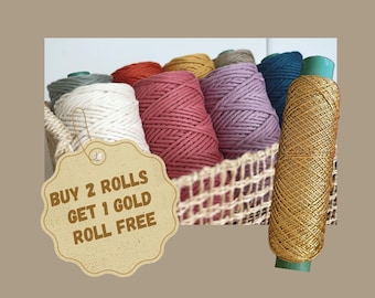 May include: A collection of colorful macrame cord rolls in a woven basket, with a gold roll on the right. The rolls are in shades of white, pink, red, purple, yellow, and teal. The image includes text that says "BUY 2 ROLLS GET 1 GOLD ROLL FREE."