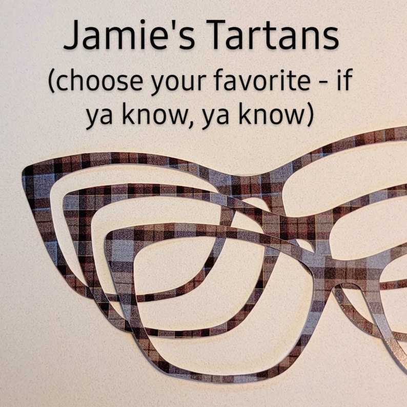 May include: Three pairs of glasses with a plaid pattern in shades of brown, gray, and blue. The glasses are layered on top of each other. The text "Jamie's Tartans (choose your favorite - if ya know, ya know)" is above the glasses.