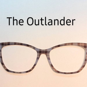 May include: A pair of black and brown cat-eye glasses with a plaid pattern.