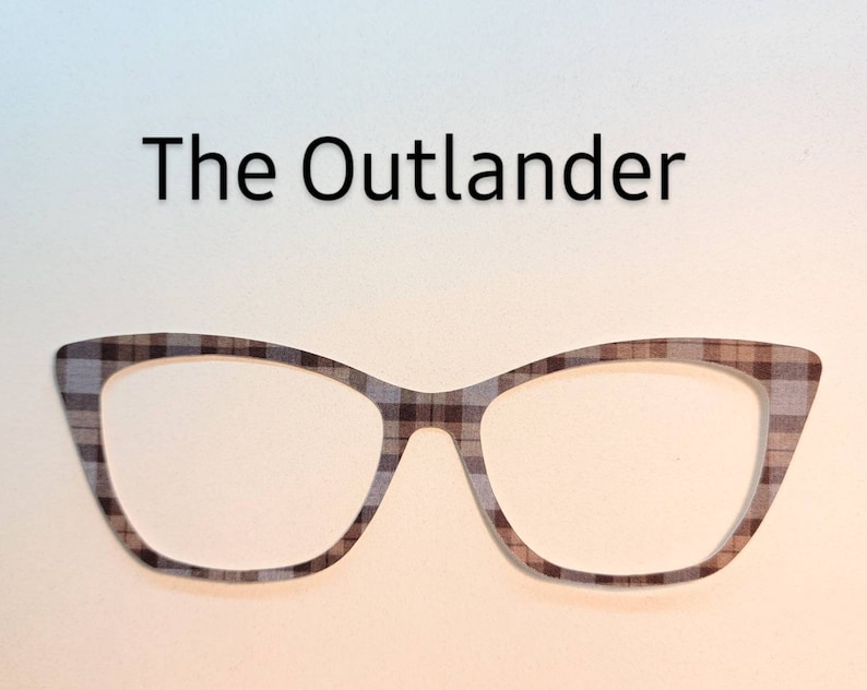 May include: A pair of black and brown cat-eye glasses with a plaid pattern.