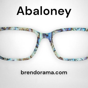May include: Abaloney eyeglasses with a blue, green, and brown abalone shell pattern. The brand name "brendorama.com" is printed below the glasses.