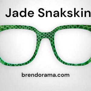May include: Green eyeglasses with a snakeskin pattern. The brand name "Jade Snakskin" is printed above the glasses and the website "brendorama.com" is printed below.