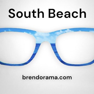 May include: A pair of blue eyeglasses with a sky and ocean scene printed on the frames. The text "South Beach" is above the glasses and "brendorama.com" is below the glasses.