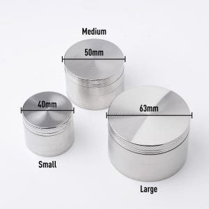 May include: Three silver metal grinders of different sizes. The smallest grinder is 40mm in diameter, the medium grinder is 50mm in diameter, and the largest grinder is 63mm in diameter.