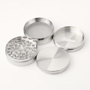 May include: A four-piece silver metal grinder with a screen, a top, a bottom, and a middle section with teeth.