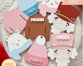 May include: A set of ten Christmas tag SVG cut files featuring various designs, including a snowman, a nutcracker, a sweater, and a hat. The tags are personalized with names like "Cash", "Mason", "Amber", and "Maeve".