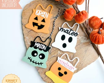May include: Four Halloween-themed cut-out designs, including a pumpkin, ghost, Frankenstein, and candy corn, each with a name. The designs are orange, white, mint green, and yellow. The image includes the text "LASER READY - INSTANT DIGITAL DOWNLOAD" and "DIGITAL SVG CUT FILE + COMMERCIAL USE".