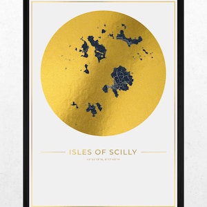 May include: A framed wall art print featuring a large metallic gold circle containing a dark blue map of the Isles of Scilly. Below the circle, the text reads ISLES OF SCILLY followed by the coordinates 49°55'19"N, 6°17'49"W in gold lettering.