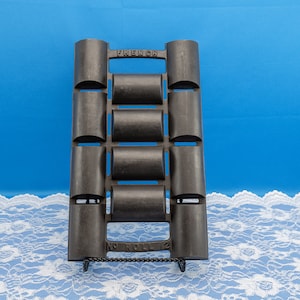 May include: Black cast iron French roll pan with 12 individual molds. The pan is labeled "French No Roll 12".