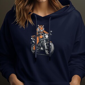 May include: A navy blue hoodie with a graphic of an orange tiger riding a motorcycle.