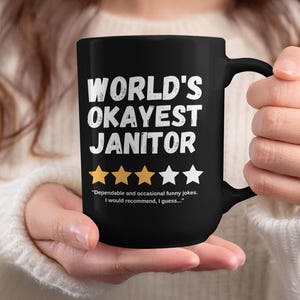World's Okayest Janitor | Black Glossy Double-Sided Ceramic Coffee Mug | Funny Sarcastic Gag Gift