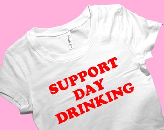 May include: White cropped t-shirt with red text that reads "SUPPORT DAY DRINKING".