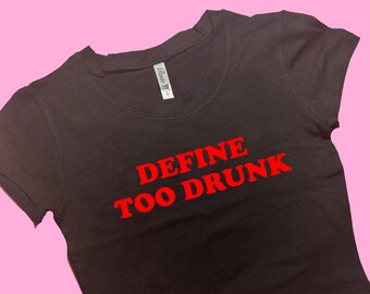 May include: Black cropped t-shirt with red text that reads "DEFINE TOO DRUNK".