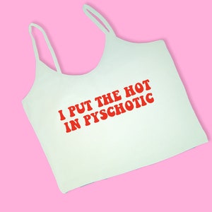 May include: White tank top with red text that reads "I put the hot in psychotic".