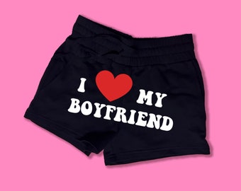 May include: Black cotton shorts with a white graphic that says "I love my boyfriend" with a red heart.