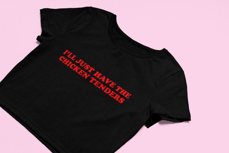 May include: Black cropped t-shirt with red text that reads "I'll just have the chicken tenders".