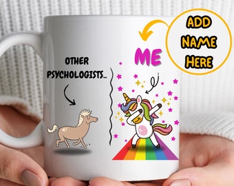 May include: White ceramic mug with a unicorn dabbing on a rainbow and the text "ME" above it. On the other side of the mug is a brown horse with the text "OTHER PSYCHOLOGISTS..." above it. The text "ADD NAME HERE" is in a yellow circle.