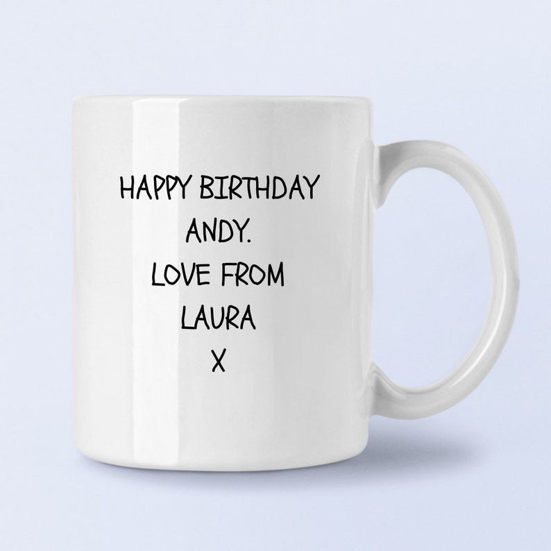 May include: White ceramic mug with black text that reads "Happy Birthday Andy. Love from Laura X".