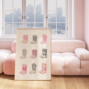 May include: A framed print of nine pairs of pink cowboy boots with different patterns, including zebra stripes, polka dots, and checkered designs.