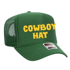 Puede incluir: Gorra de camionero verde con las palabras "COWBOY HAT" en letras amarillas. La gorra tiene una parte trasera de malla y una visera curva. La gorra tiene una etiqueta en la visera.