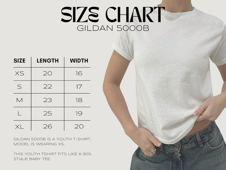 May include: Size chart for a Gildan 5000B youth t-shirt. The chart shows sizes XS through XL with corresponding length and width measurements in inches. The model is wearing a size XS.