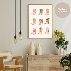 May include: A printable wall art print featuring a collection of 12 pink, white, and brown cowboy boots with various patterns. The boots are arranged in a grid pattern on a white background.