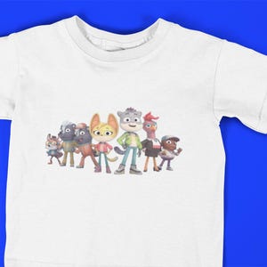 May include: White t-shirt with a colorful cartoon image of a group of animal characters. The characters are a gray wolf, a yellow cat, a gray raccoon, a brown bear, a pink bird, and a brown squirrel.