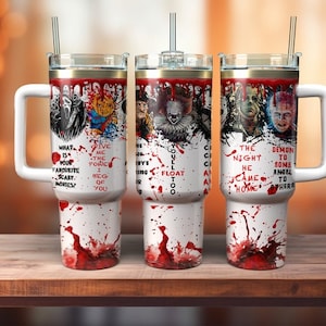 May include: Three white insulated tumblers with handles, each featuring horror movie characters and blood splatter designs. Text includes phrases like "What is your favorite scary movies?" and "You'll float too."