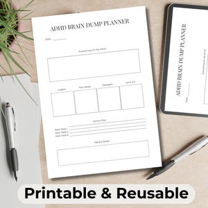 May include: A white ADHD Brain Dump Planner with sections for notes, action plans, and mental resets. The planner is accompanied by a tablet, pens, and a small plant. The text "Printable & Reusable" is at the bottom.