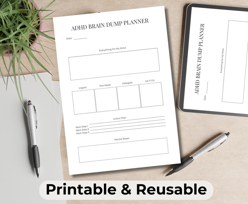 May include: A white ADHD Brain Dump Planner with sections for notes, action plans, and mental resets. The planner is accompanied by a tablet, pens, and a small plant. The text "Printable & Reusable" is at the bottom.