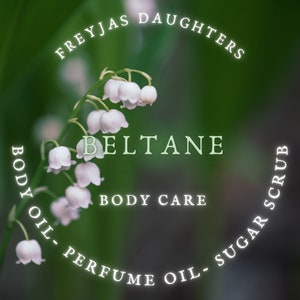 May include: A close-up of white lily of the valley flowers with a green background. The text "Freyjas Daughters" and "Beltane" are written in a circle around the flowers. The text "Body Oil - Perfume Oil - Sugar Scrub" is written in a circle around the flowers. The text "Body Care" is written below the flowers.