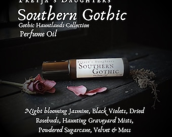 May include: A perfume oil bottle with the label "Southern Gothic" from Freyja's Daughters, part of the Gothic Hauntlands Collection. The image features dried rosebuds and petals. Scent notes are listed below the bottle.