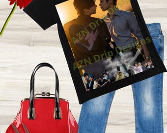 May include: Black t-shirt with a graphic featuring two people and the text "REVENGE LOVE" and "AZN Drip Designs". The image also includes blue jeans, a red handbag, and red high heels.