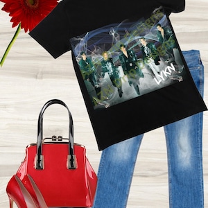 May include: Black t-shirt with a graphic print of a band called "LYKN". The band members are wearing black clothing and are standing in front of a blue and green background. The t-shirt is paired with blue jeans, red high heels, and a red handbag.