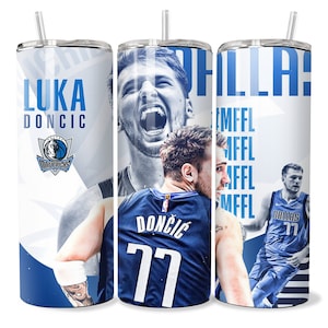 May include: A white and blue stainless steel tumbler with a basketball theme. The tumbler features a photo of Luka Doncic, a basketball player for the Dallas Mavericks, with the team logo and the words "Luka Doncic" and "Dallas 77".