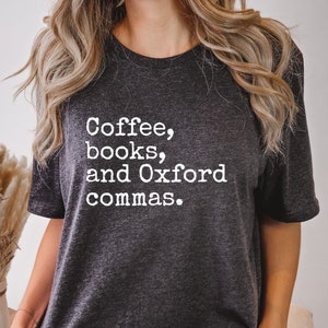 May include: A dark gray t-shirt with the text "Coffee, books, and Oxford commas." printed in white.