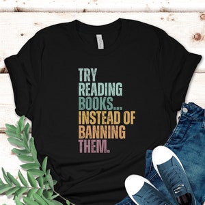 May include: Black t-shirt with a vintage-style graphic that reads "TRY READING BOOKS...INSTEAD OF BANNING THEM."
